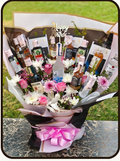 A promotional product listing for a 'Birthday Buzz Luxe' gift set by DrapedNuts. The image features a central photo of a 18-piece gourmet gift basket filled with chocolates, biscuits, and a pink wrapped bouquet, set against a cream-colored background with a product list and price of ₹14999.